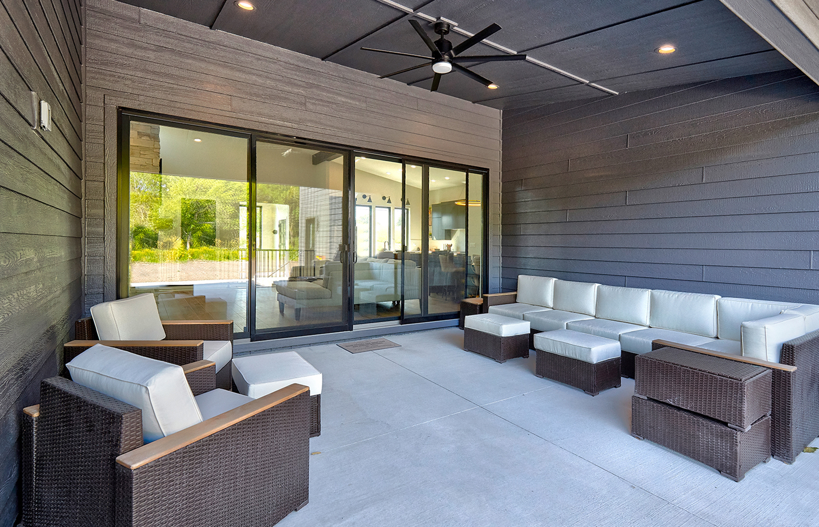 custom patio area with outdoor seating looking at double sliding glass doors