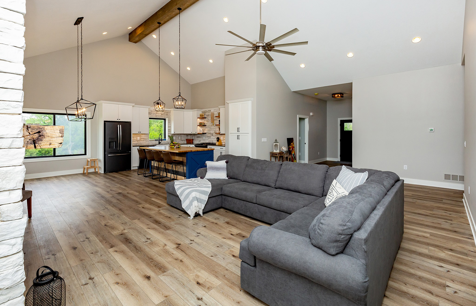 Large gray sectional couch in great room overlooking kitchen