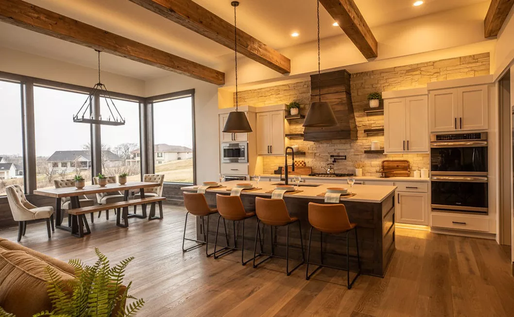 Let's-Build-Together Kitchen with stone backsplash, brown leather stools, and a large kitchen table overlooking backyard