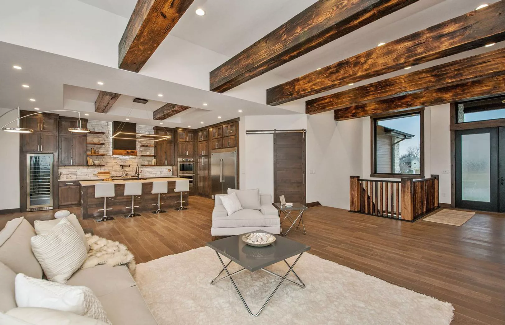 large wooden beams over open concept living area