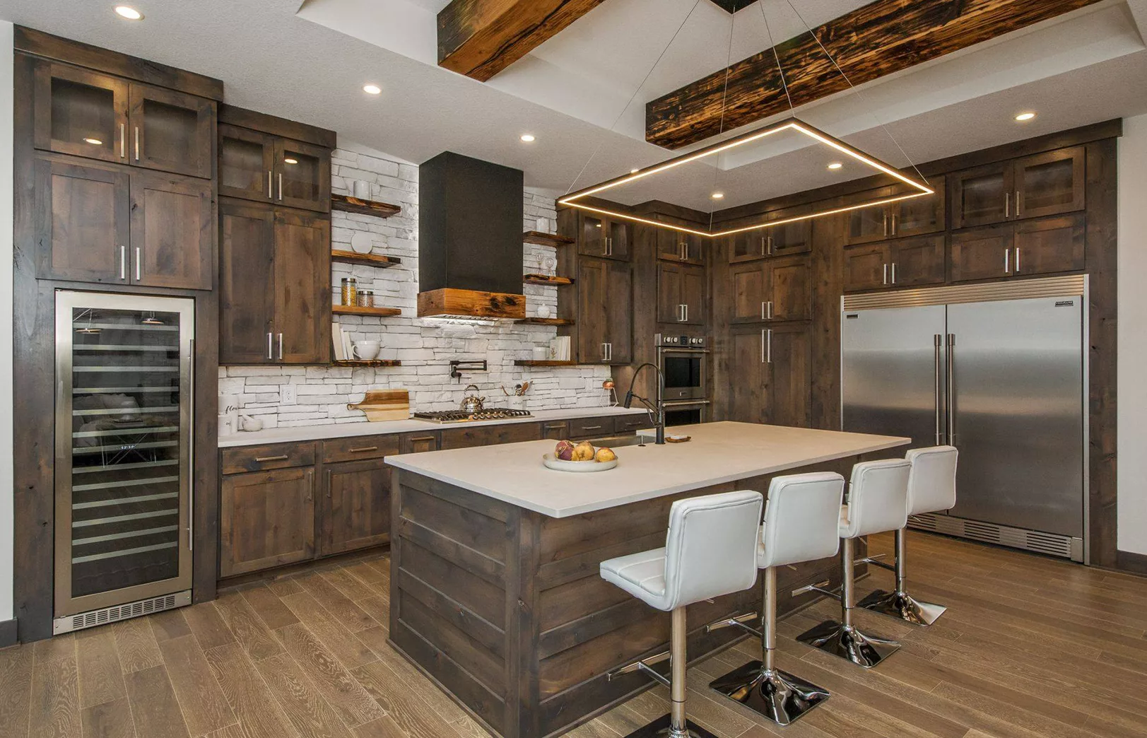 open eat-in kitchen with large wooden beams and dark stained wood cabinets