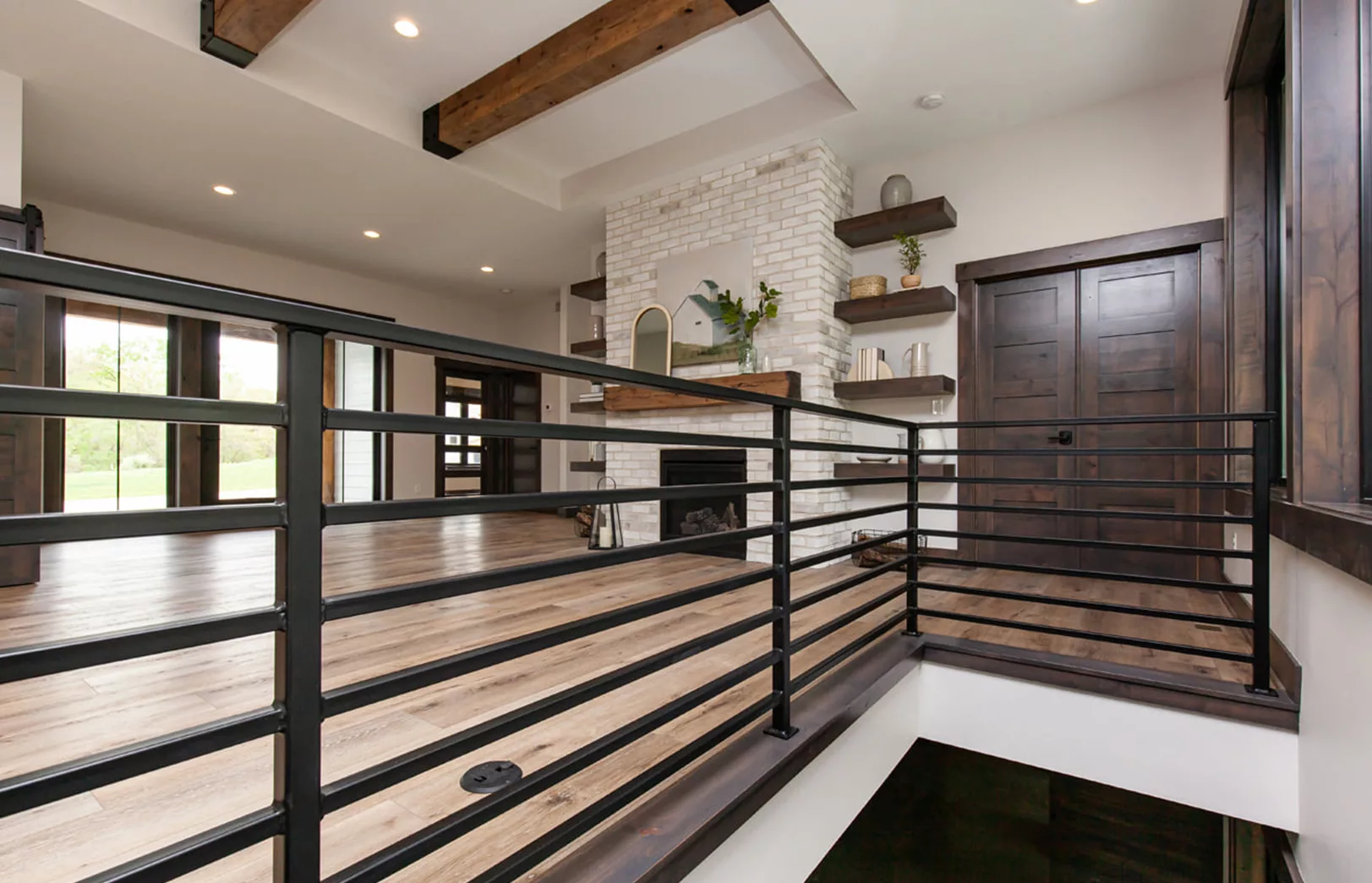 wrought iron railing looking into open concept living area